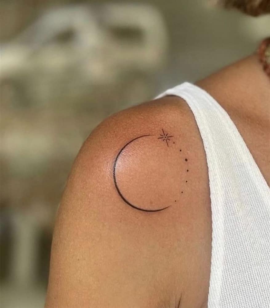 Fine-line crescent moon and star tattoo